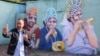 RUSSIA – MOSCOW,JULY 3, 2018: A mural by street artist Alex Melentyev depicting Inna Kalenskaya, her husband Dmitry Gnatyuk and nephew Yuri Gnatyuk, football fans who wore kokoshniks [traditional Russian headdress] and had a snack during the 2018 FIFA Wo